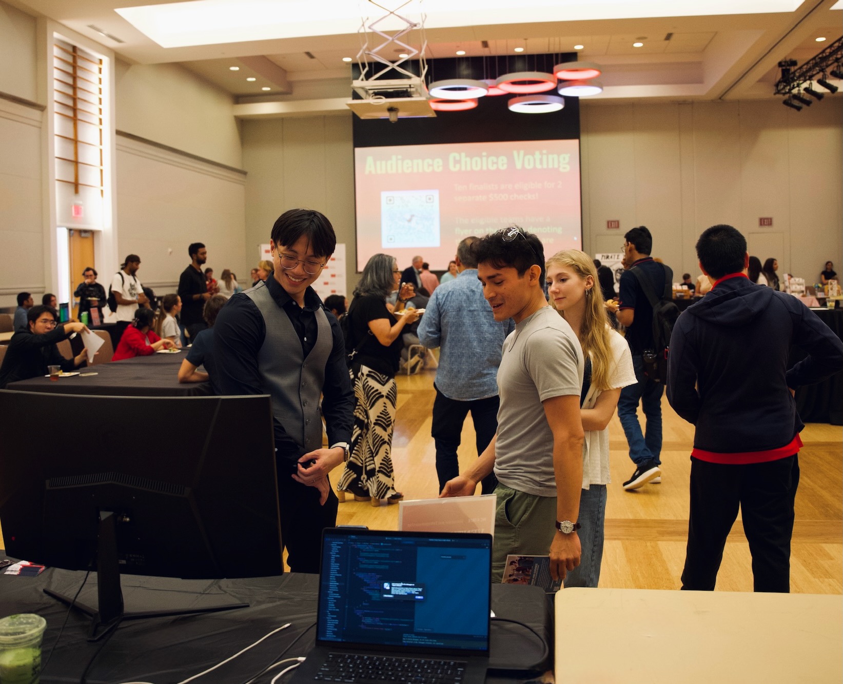 Matt demonstrating Tripure app to interested visitors at the event booth